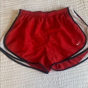 Red Nike running shorts, size L